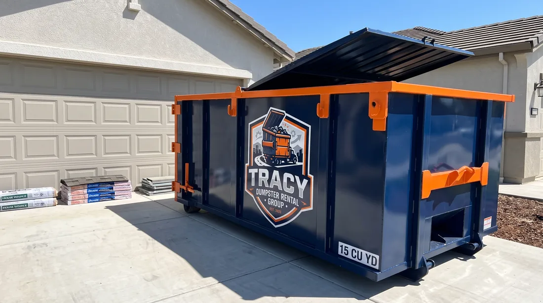 Residential dumpster rental on a driveway in Tracy, CA during a home cleanout